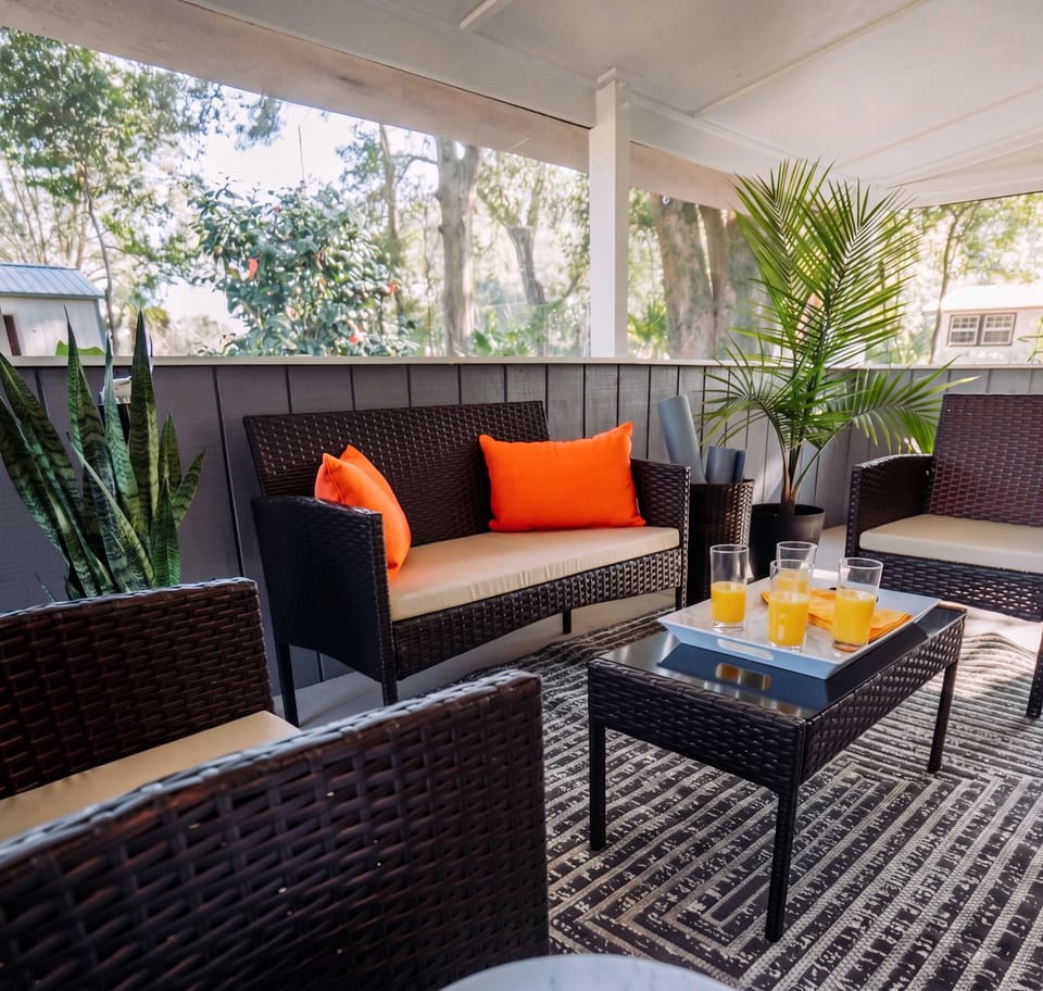 Outdoor living, elevated. Kick back on the wicker sectional and soak in the lush garden views.