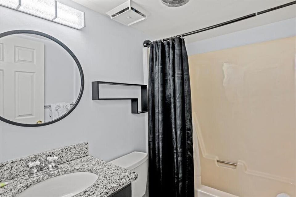 Fresh and stylish! Our second bathroom features a brand-new vanity, sleek sink, modern mirror, and updated lighting...designed for both comfort and style.