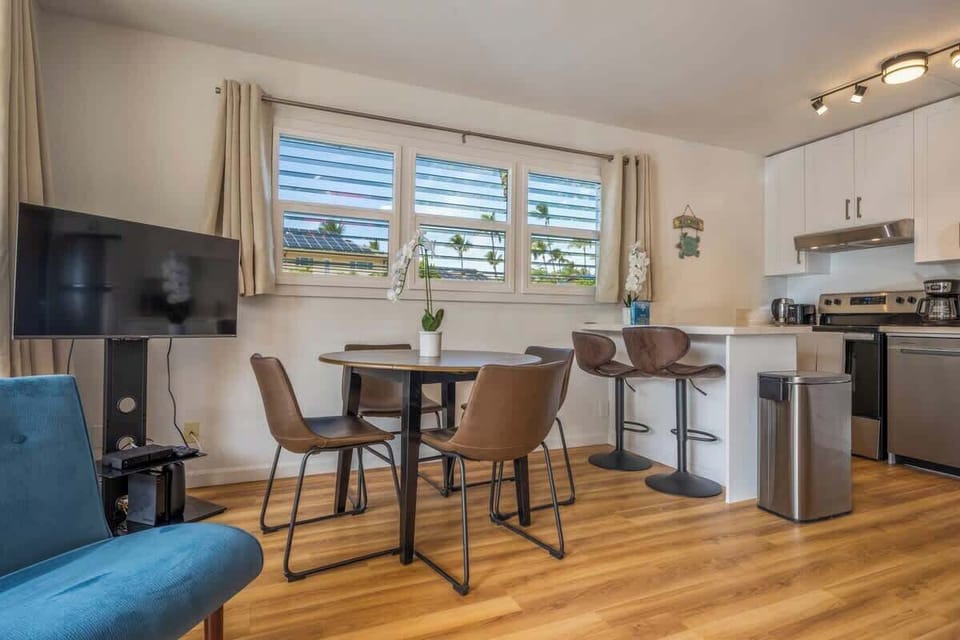 Plenty of seating in the living are between the dining table and breakfast bar. New windows were installed also to see the ocean from the kitchen area.
