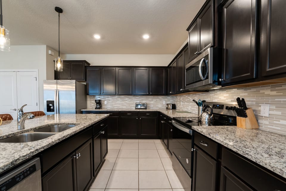 Kitchen showing granite countertops and plenty of space to gather