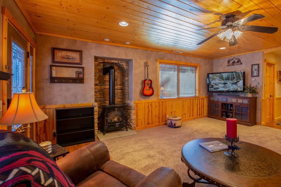 Cozy family room with gas fireplace, TV with Roku, and acoustic guitar.