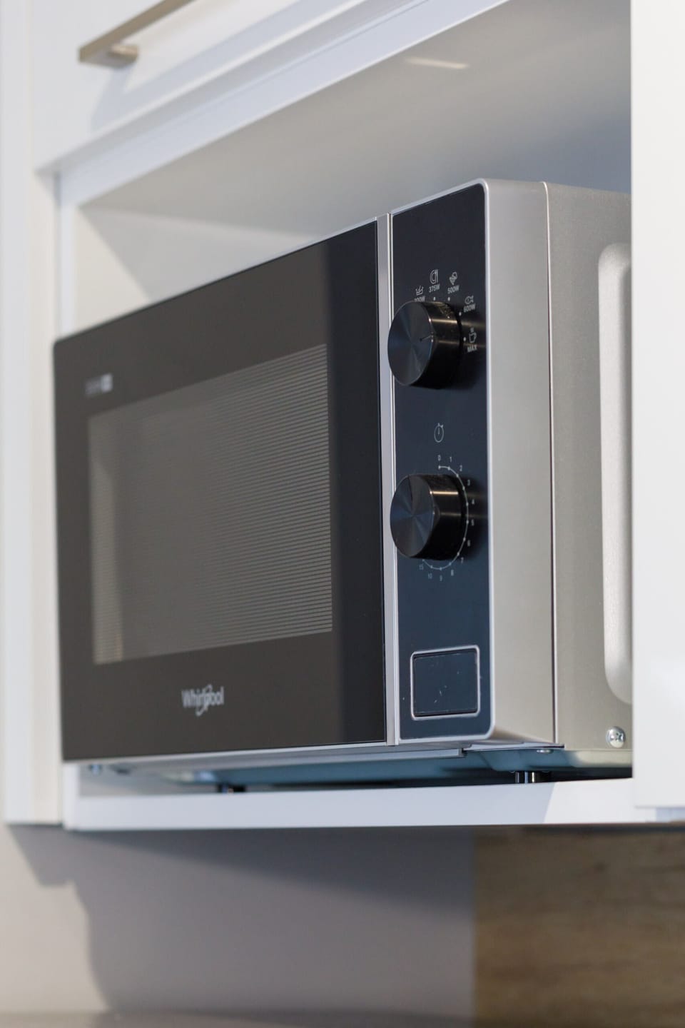 A close-up of a built-in microwave in the kitchen, highlighting its practical features.
