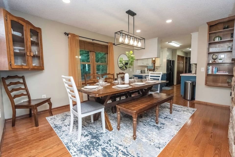 The dining room is adjacent to the kitchen. There are plenty of dishes, glasses and silverware for your large group. 
