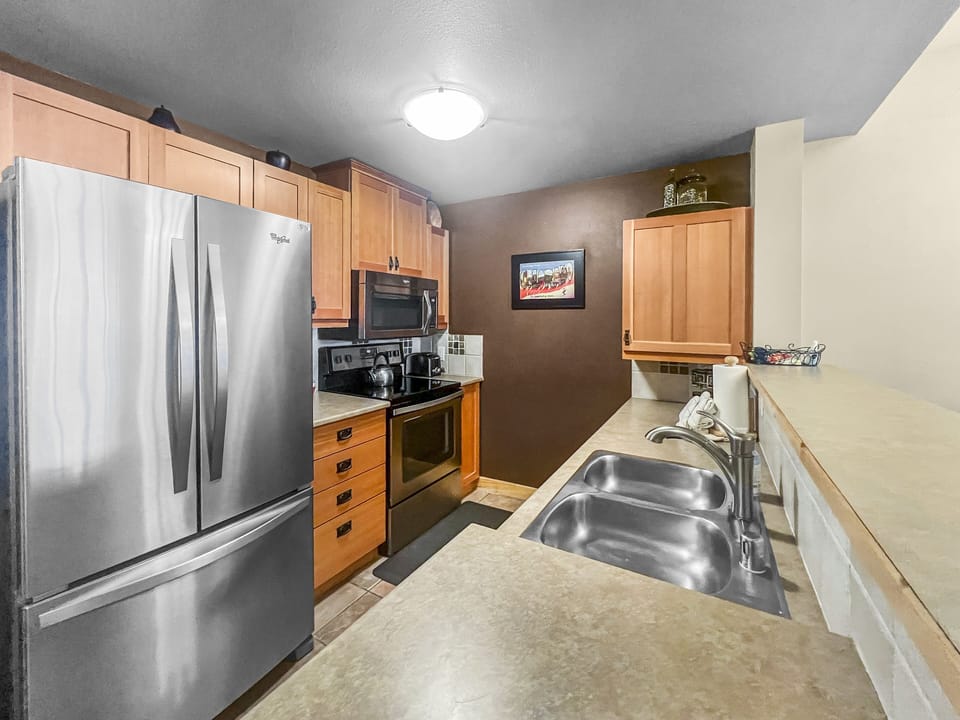 The kitchen features stainless steel appliances.
