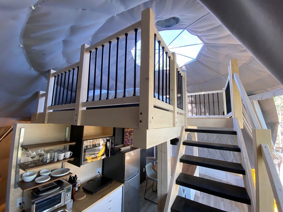 A few steps up to the mezzanine where a very large and cozy bed awaits you under the starry sky.