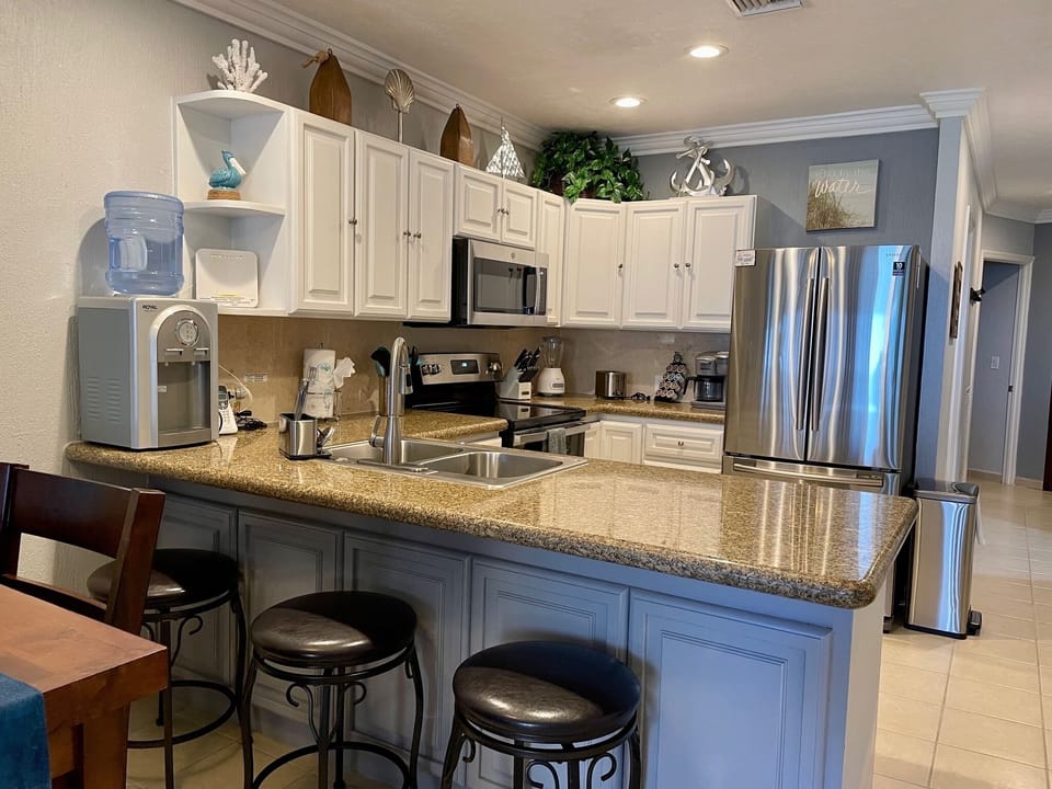 Fully stocked kitchen. Notice the chilled bottled water dispenser!