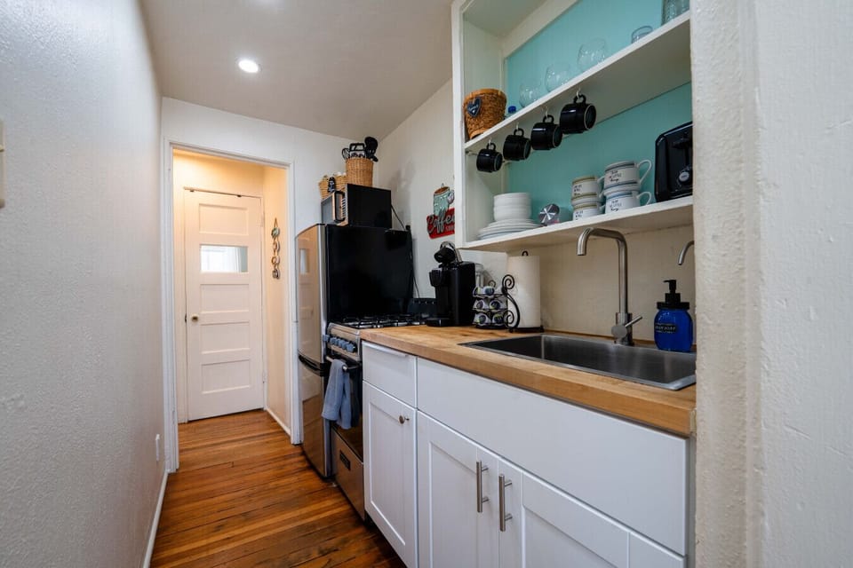 Cook up a storm in this stylish space with modern appliances and sunny vibes!