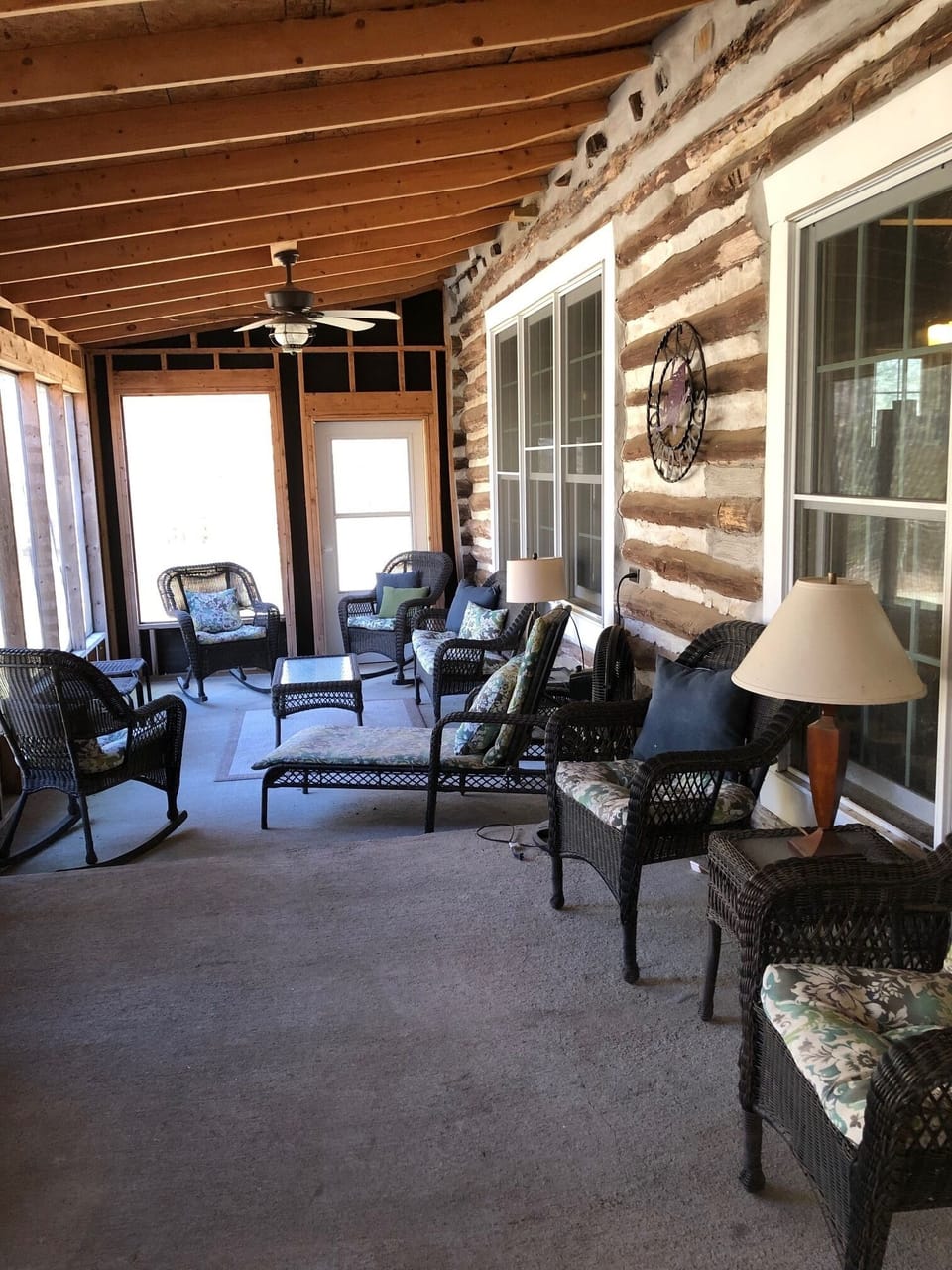 Plenty of seating to relax on the front screened-in porch.