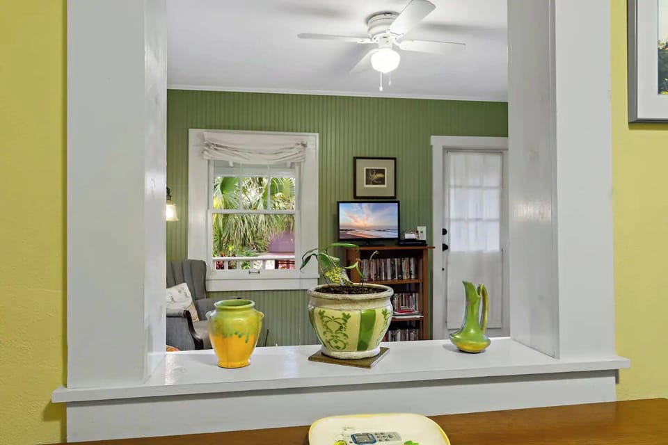 View of living room and front door from kitchen.