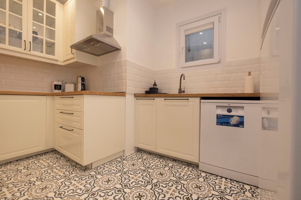 The kitchen - glass-fronted cabinets and the tiled floor