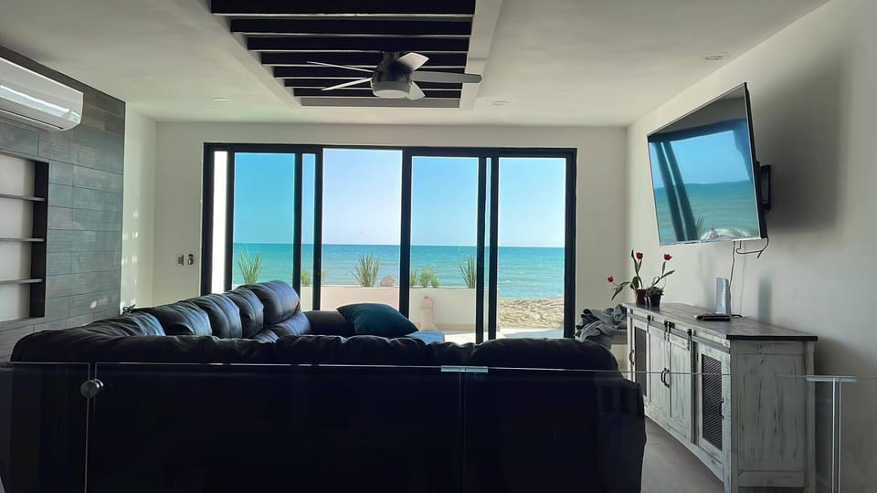 Downstairs Family room with large sectional couch. Looking at ocean