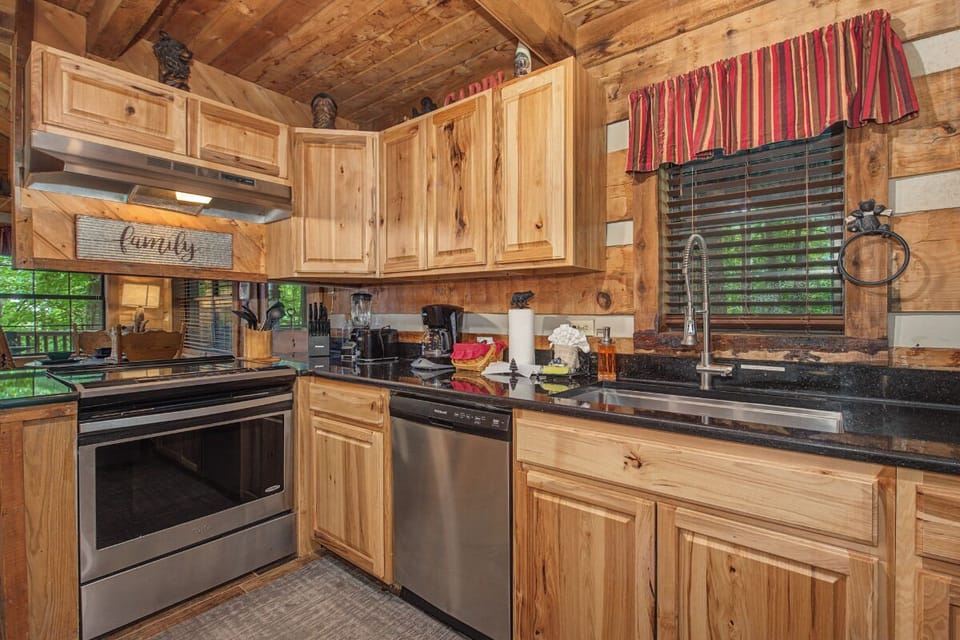 Gather in your fully-equipped rustic kitchen, where handcrafted wood cabinetry meets modern appliances, creating the perfect space for shared meals and memories.