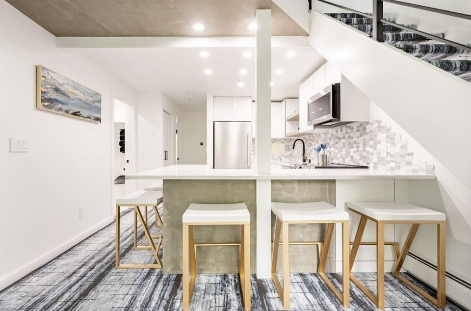 Dinning area with West Elm dish ware and champagne silverware.