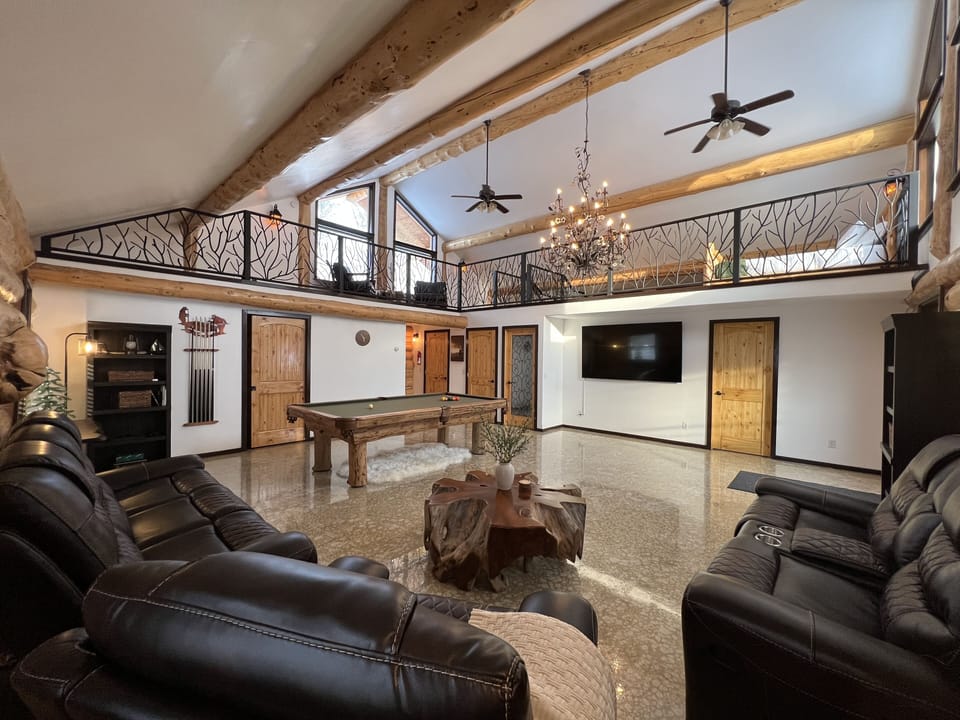 Main level great room. Pool table, big screen tv, sound system, games!