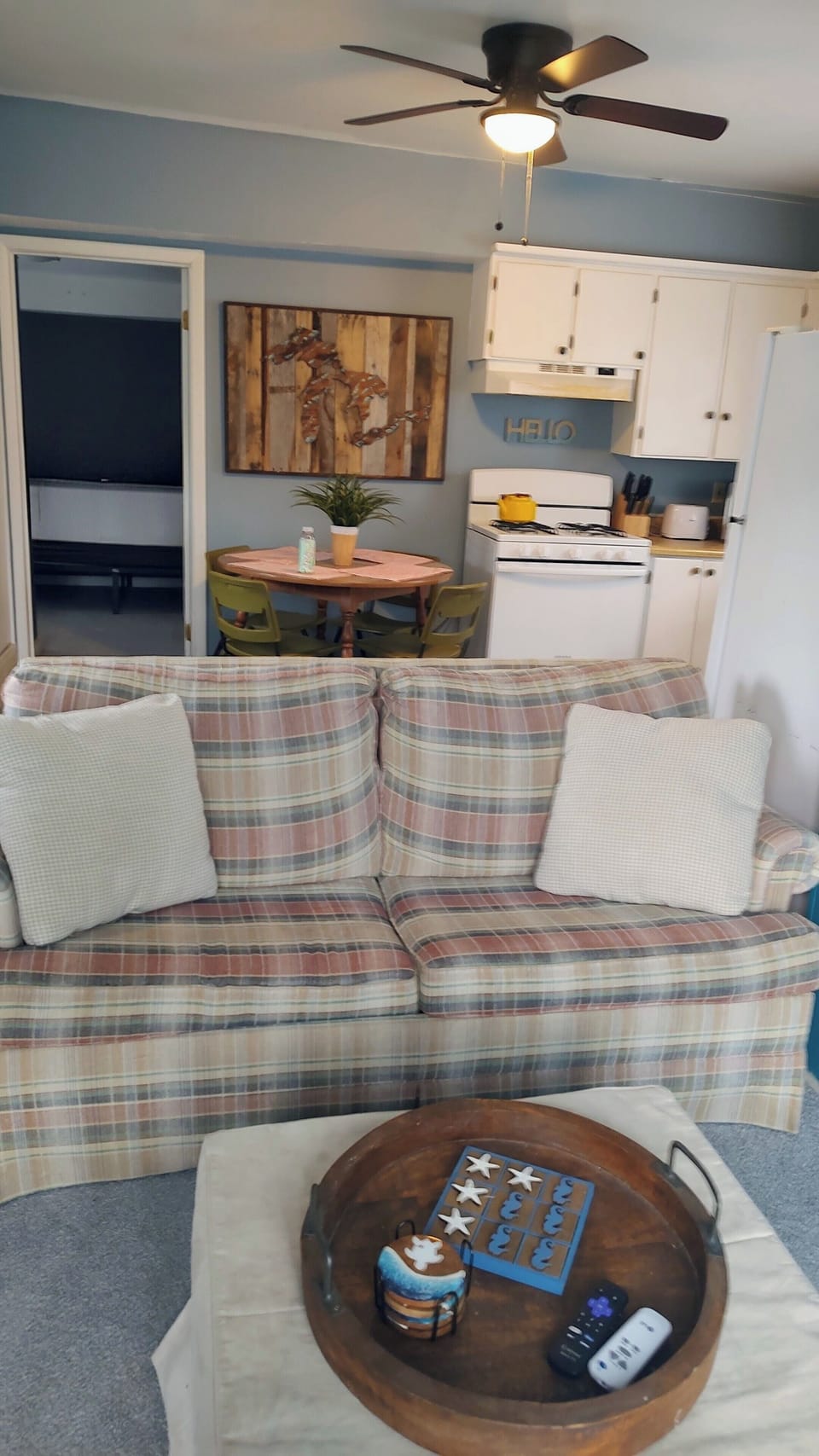 Couch in Living room facing bedroom and kitchen 