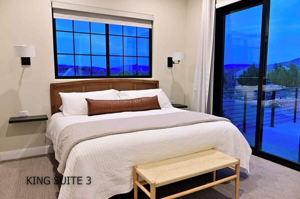 Upstairs king suite 3 with attached bath room and large 55" TV. Dreamcloud mattress bed.  USB-C and USB-A chargers at each bedside table. Access to balcony shared with king suite 2.