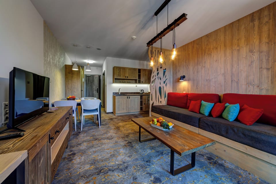Family Apartment | Living area | 100-cm flat-screen TV with satellite channels, TV