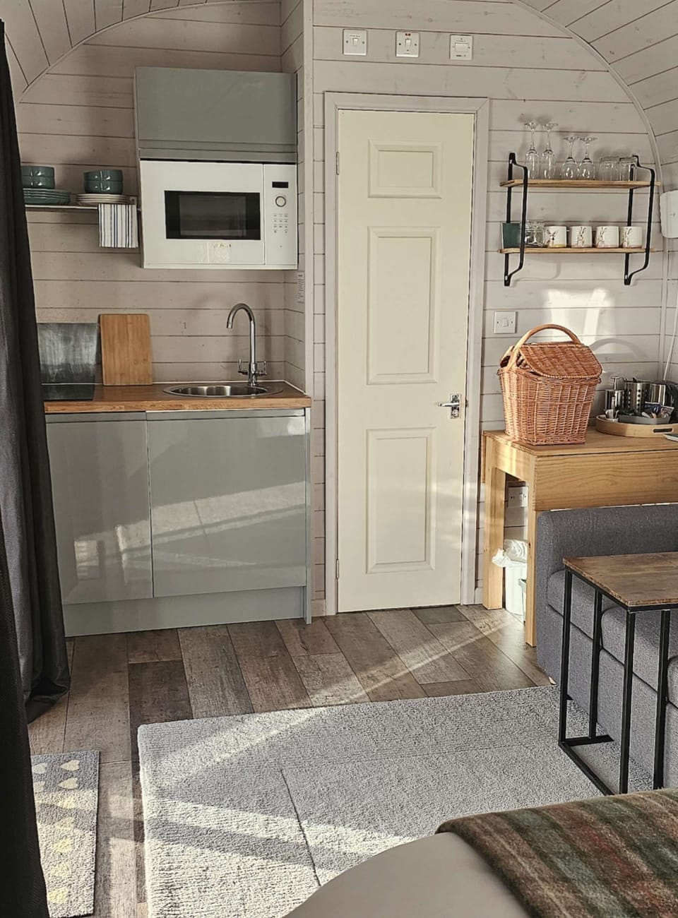 The kitchen area comes equipped with a two-ring induction hob, microwave, toaster, kettle, fridge freezer, crockery, cuttlery, cooking utencils, pots and pans.