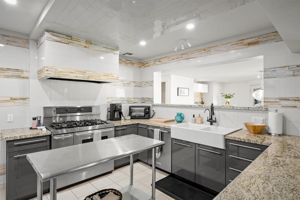 Fully stocked kitchen with essentials and cookware, dishes for 12+ guests
