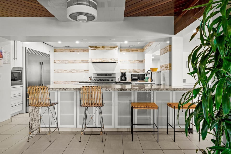 The large kitchen counter includes 4 stools facing the kitchen and 2 more stools around the other side in the dining room.  Plenty of seating for a larger group to dine together inside!