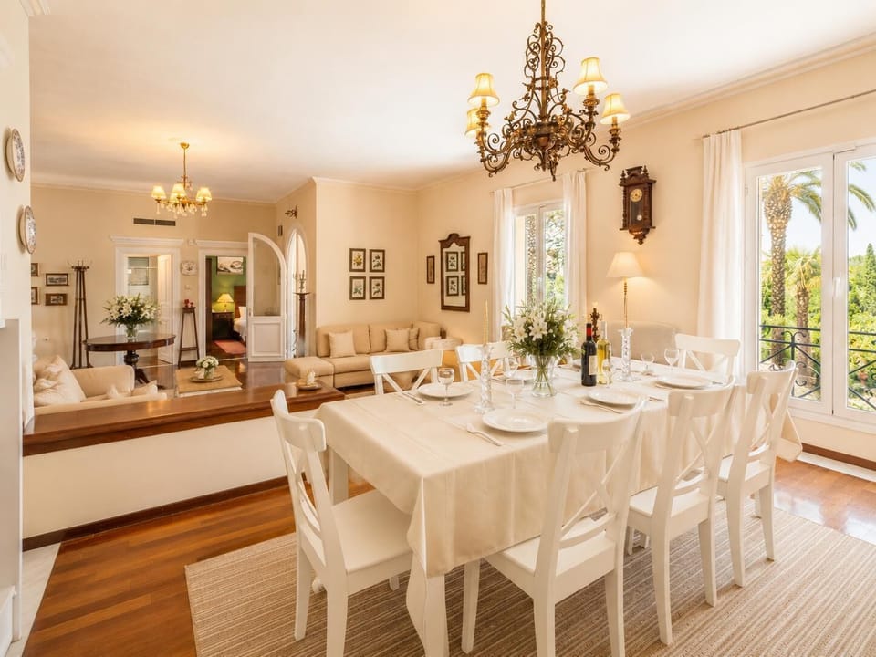 Living room with sofas, dining area, ornamental fireplace, WiFi internet, and satellite TV