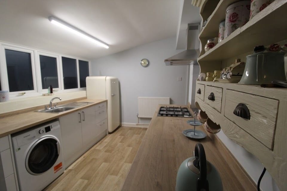 Kitchen includes fridge with freezer compartment