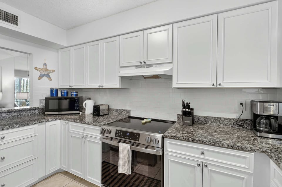 Step into the bright and cheerful kitchen, the heart of this home, where granite countertops set the stage for culinary adventures.