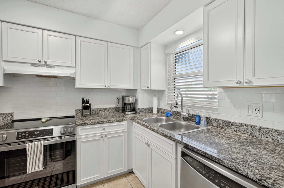 The heart of the home features a bright space with granite countertops, perfect for preparing delicious meals and enjoying cheerful gatherings.

