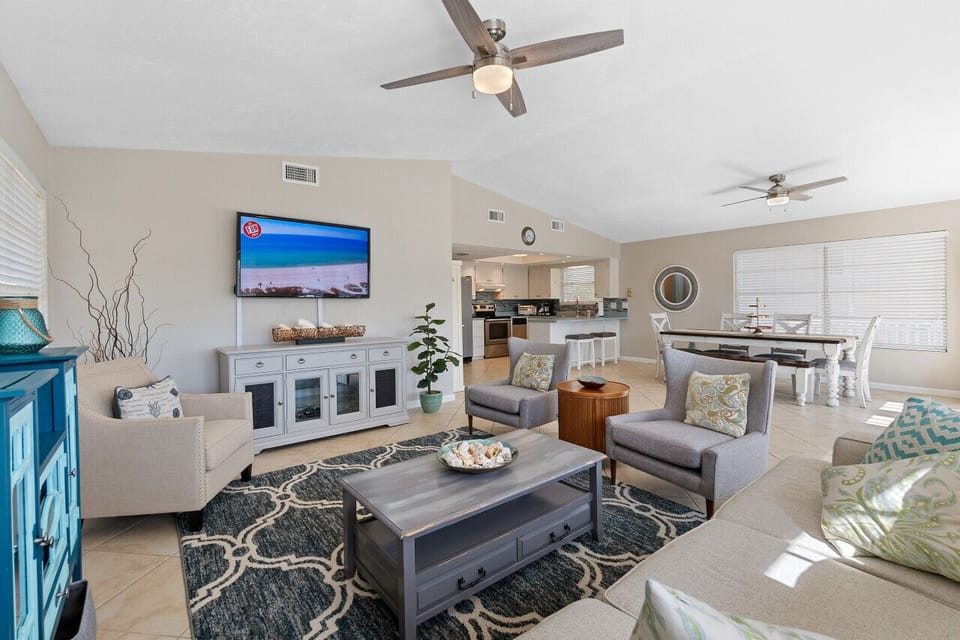 Spacious living area with large TV and plenty of comfortable seating.