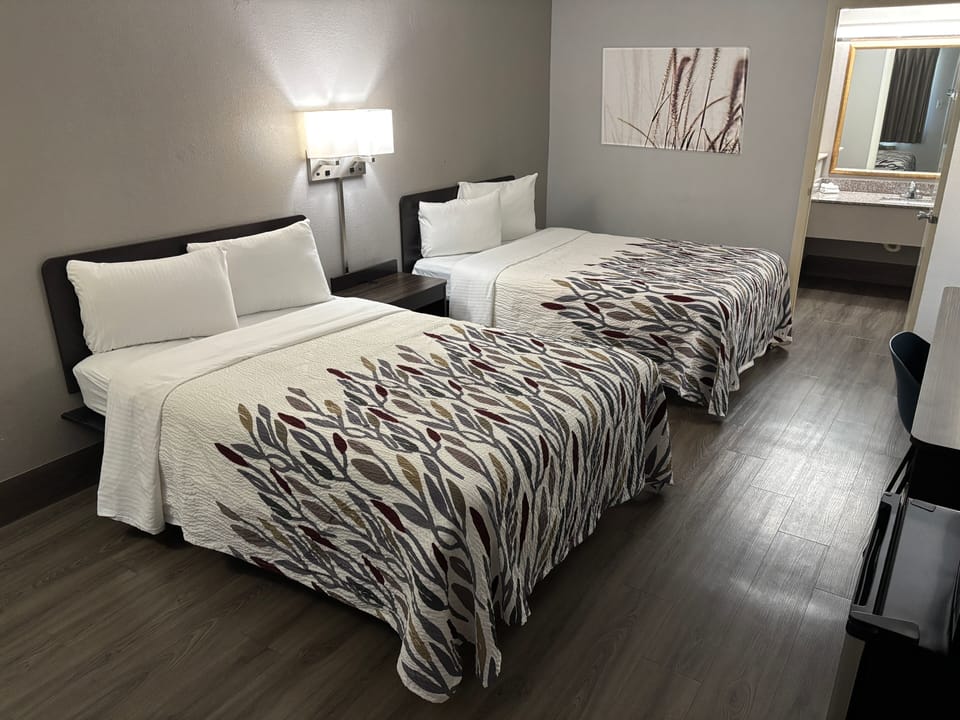 Premium bedding, desk, laptop workspace, blackout drapes