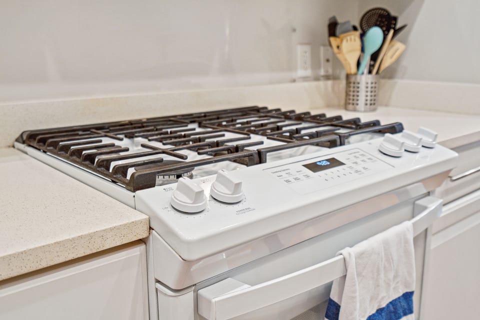 Gas stove in fully stocked kitchen