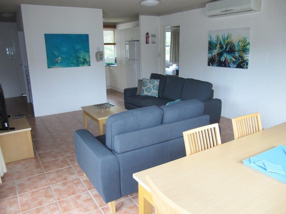 Different floor plan: Dining, lounge (centre) and kitchen (in the distance)
