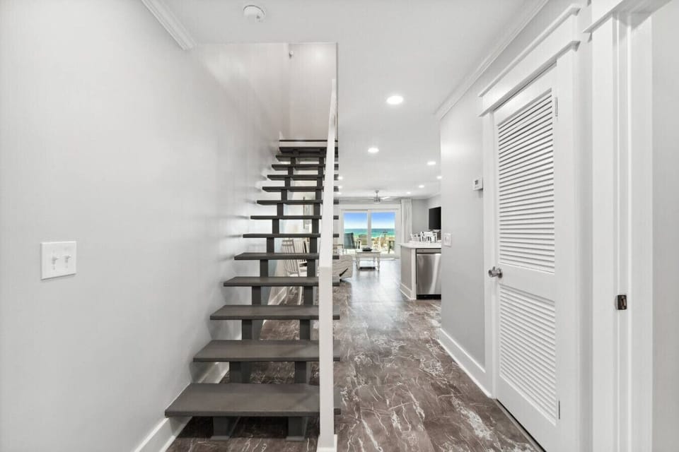 Upon entering the home, you are welcomed by an open-floor concept and ocean views.