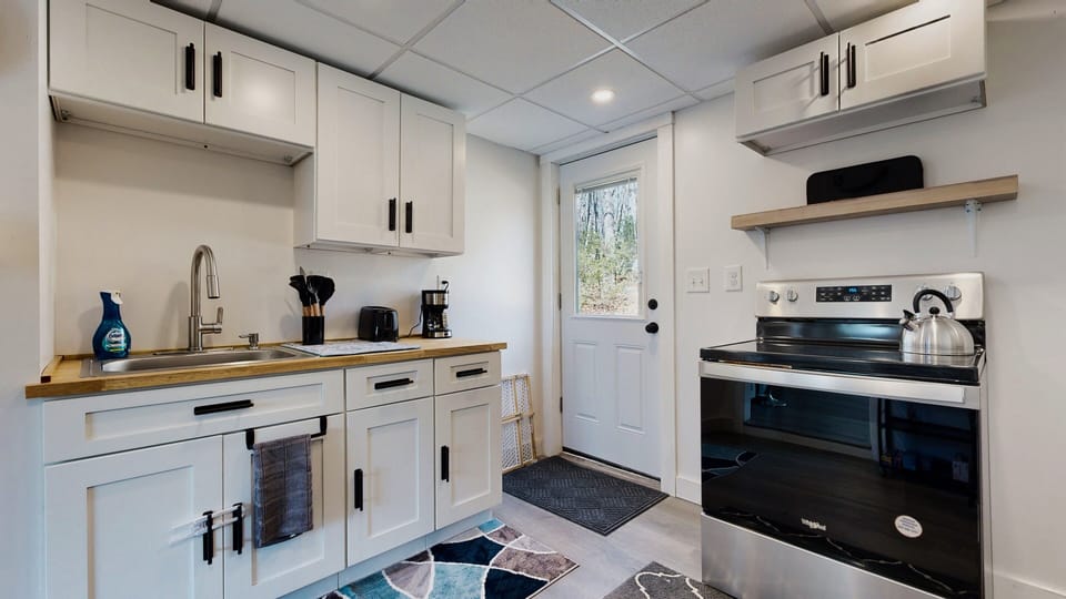 Kitchen sink and stove. The backdoor to go to the firepit.