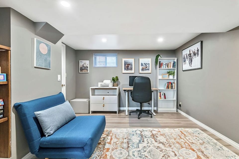 Office area includes monitor, printer and electric desk. 