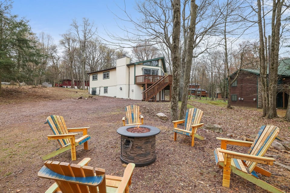 Exterior of home with propane fire pit and seating area.