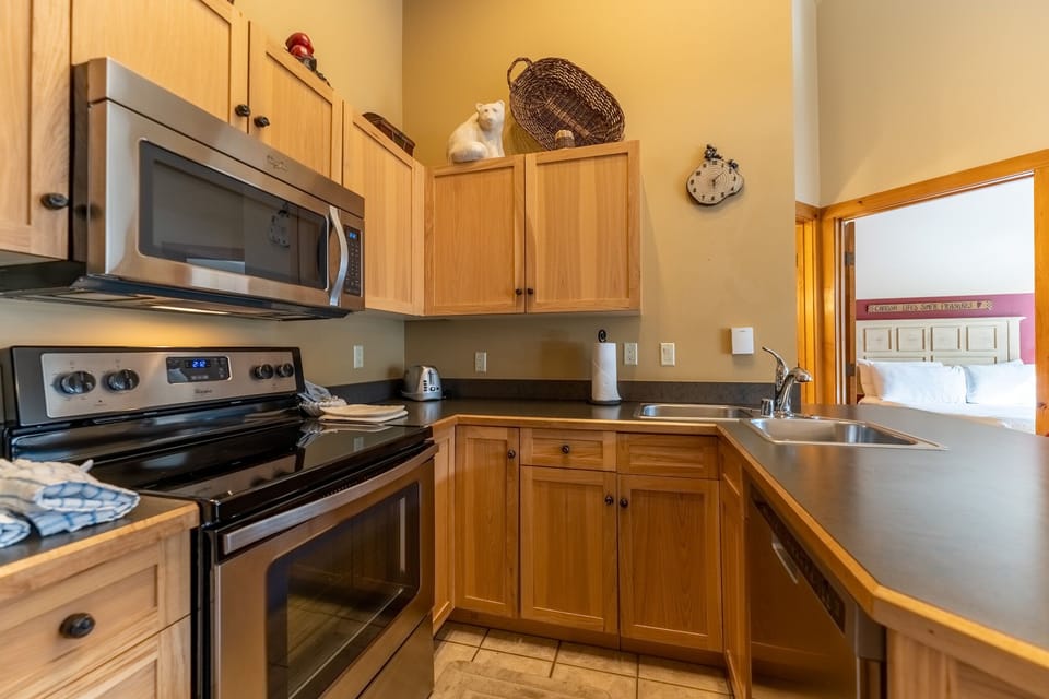 Your fully equipped kitchen features warm wood cabinets, stainless appliances, and everything you need to prepare delicious meals during your stay.