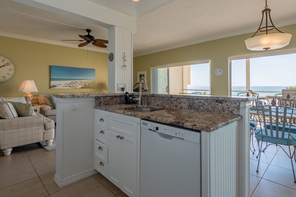 Fully equipped kitchen with dishwasher, full size fridge, and electric range