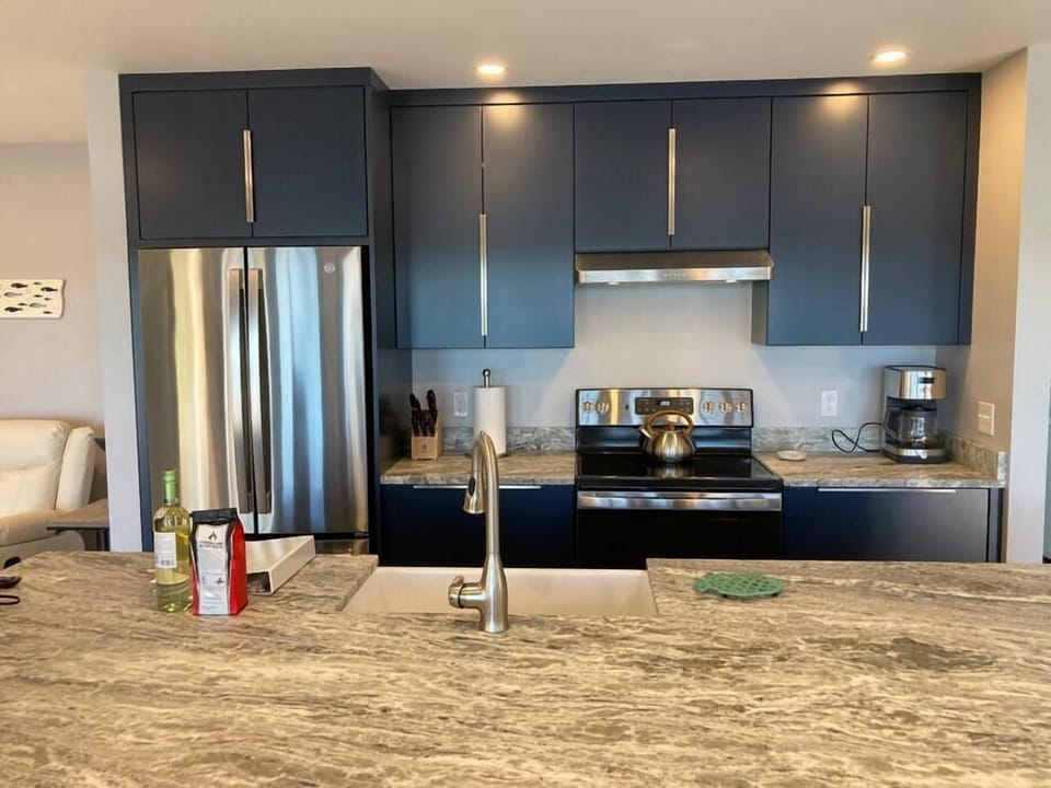 Eat-in buffet faces kitchen for interacting with friends and family.
