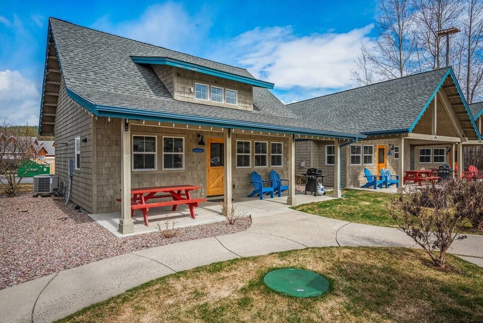 The patio has a picnic table, chairs and a propane BBQ.