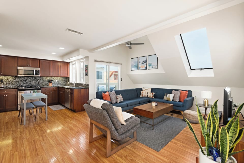 Spacious living room featuring comfortable seating, modern decor, and ample natural light