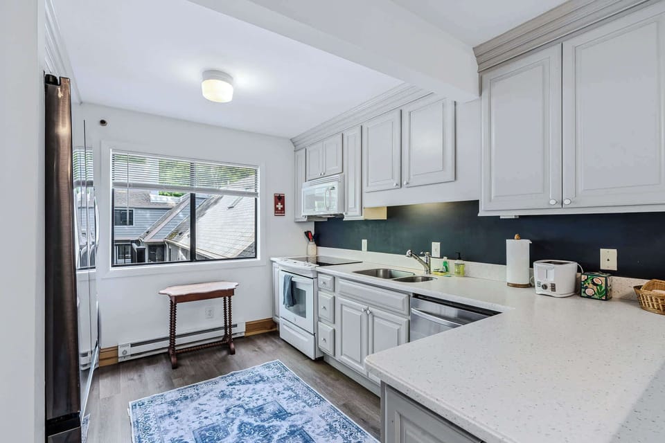 Modern Kitchen — White Cabinets, Quartz Counters & Navy Backsplash