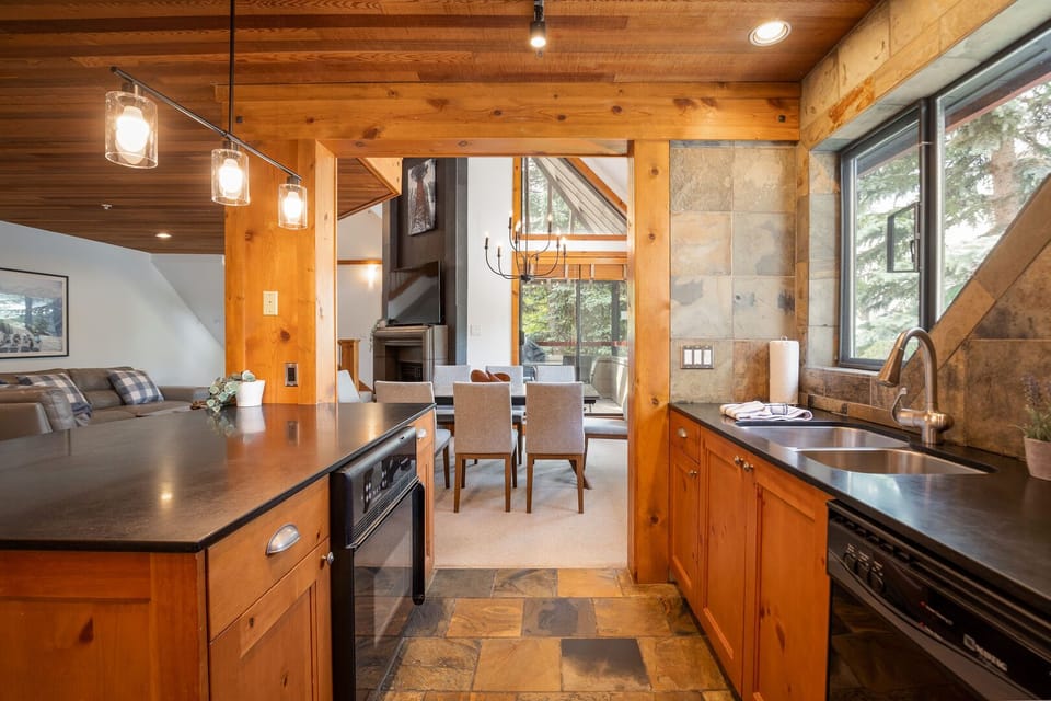 The kitchen features sleek countertops, a full-size stove, dishwasher, microwave, and everything you need to dine in.