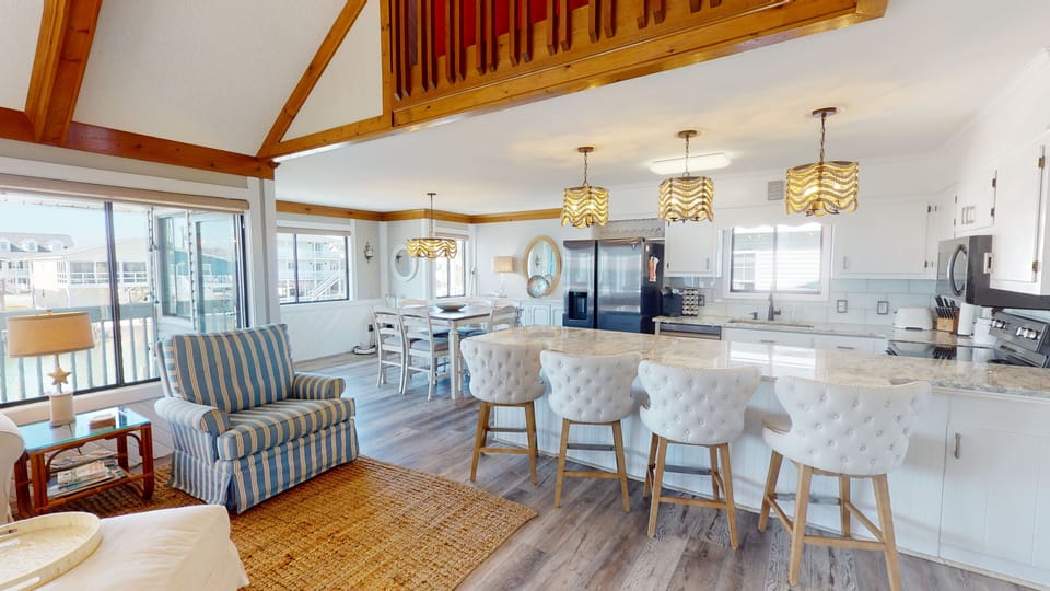 Spacious and beautifully styled, this open-concept design blends modern comfort with beachside elegance—ideal for gathering and entertaining.