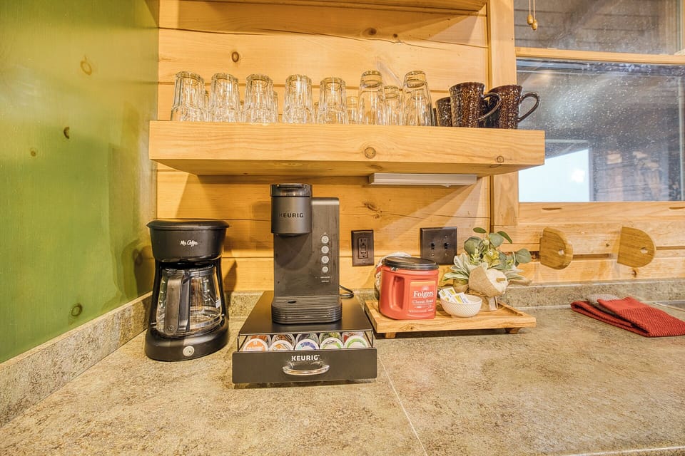 Start your day at the coffee bar w/ Keurig, brewer, mugs, & granite counter.