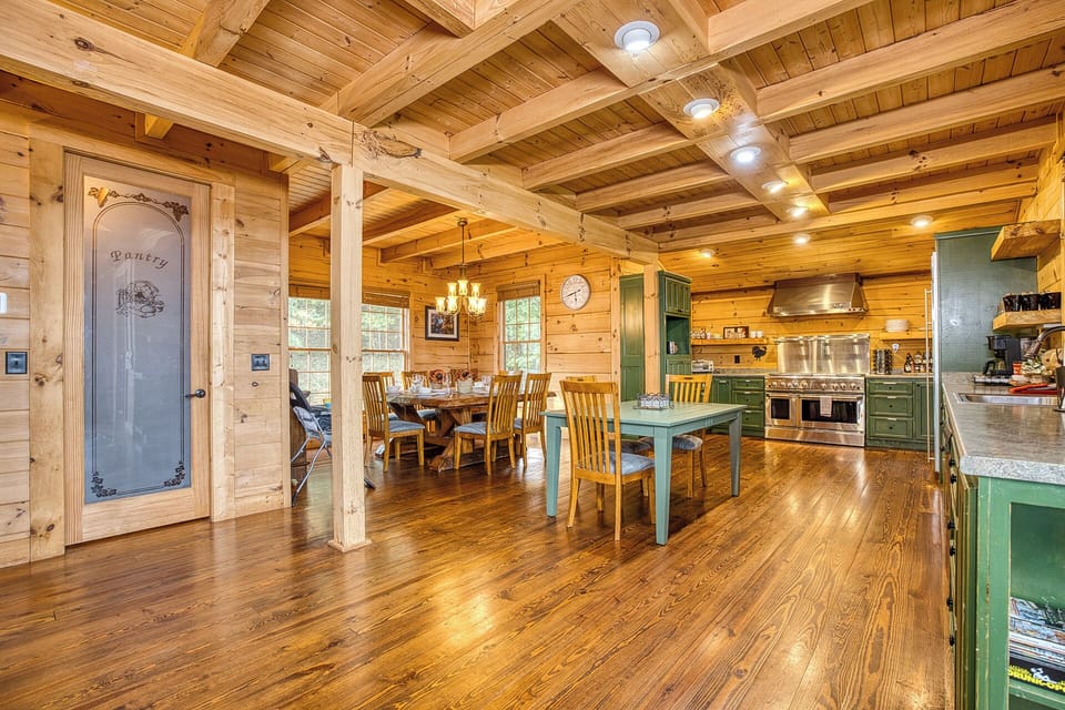 Cook in a gourmet kitchen w/ double ovens, granite, beams, and cozy lighting.