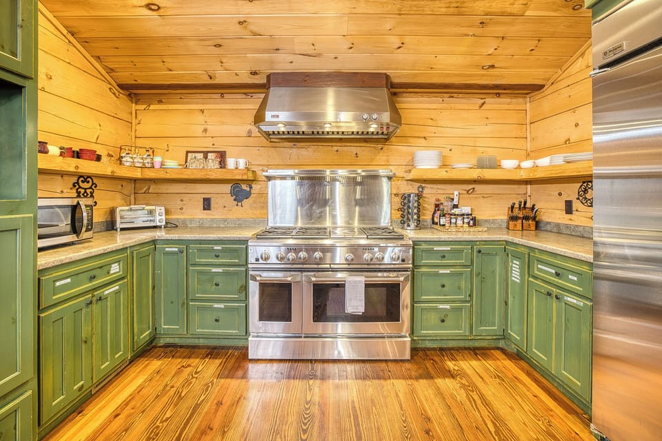 Cook in a gourmet kitchen w/ gas range, dual ovens, granite, & green cabinets.