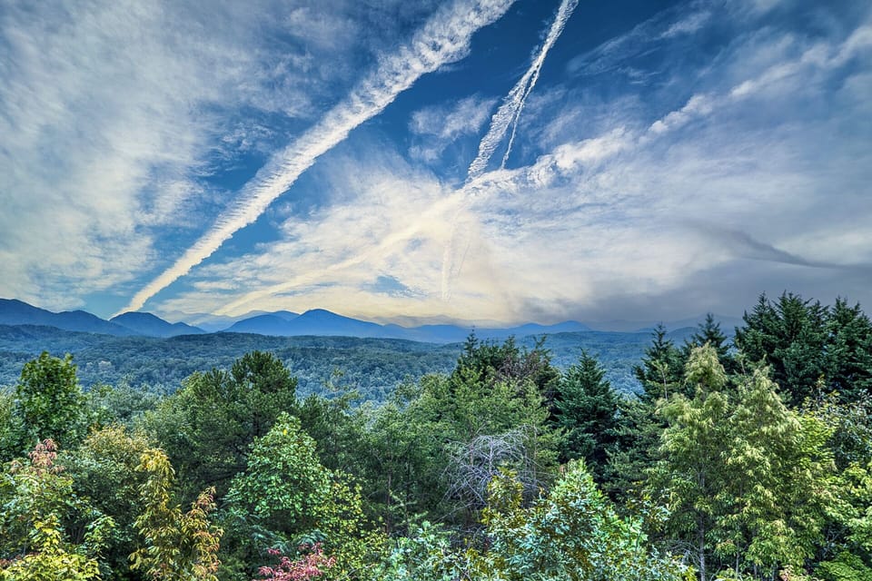 Wake up to mountain views, trees, and clouds—your peaceful cabin escape.