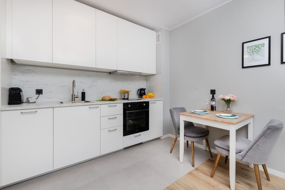Kitchenette with oven and refrigerator. 