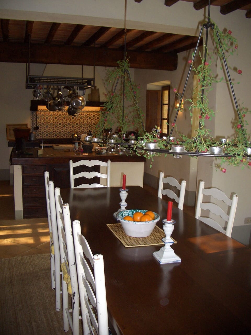 Lookint over the dining table towards the kitchen behind